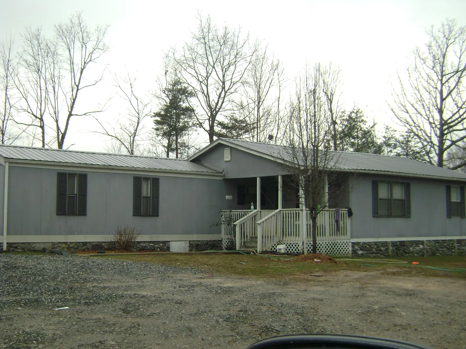 Metal roof over a manufactured home with a covered front porch in Liberty Center